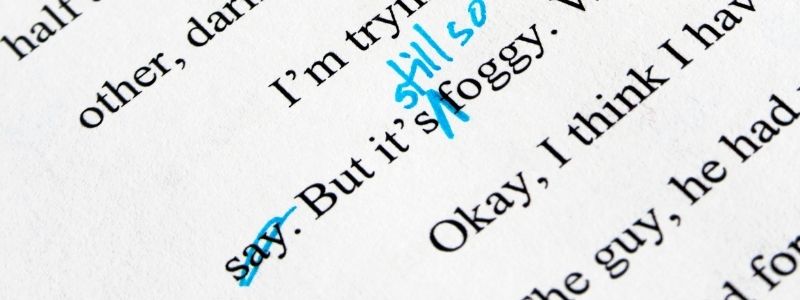 Mark-up edits on a manuscript in blue pen